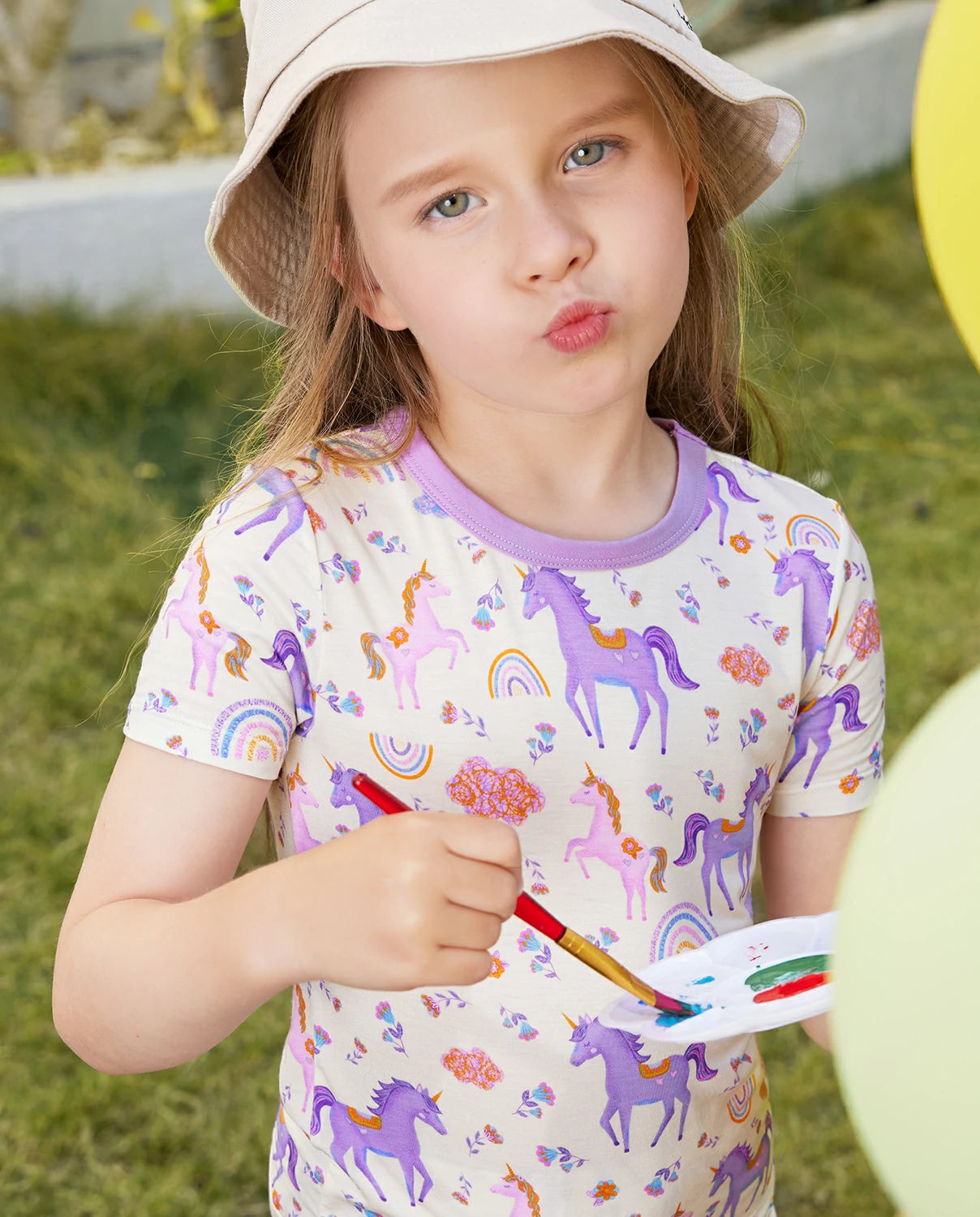 Lavender Unicorn Short Two-Piece Pajama Set - child wearing the short pajamas while painting outdoors