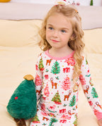 Close view of a child holding a plush Christmas tree in Blush Christmas pajamas.