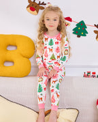 Child seated on a sofa in the white Blush Christmas two-piece set.
