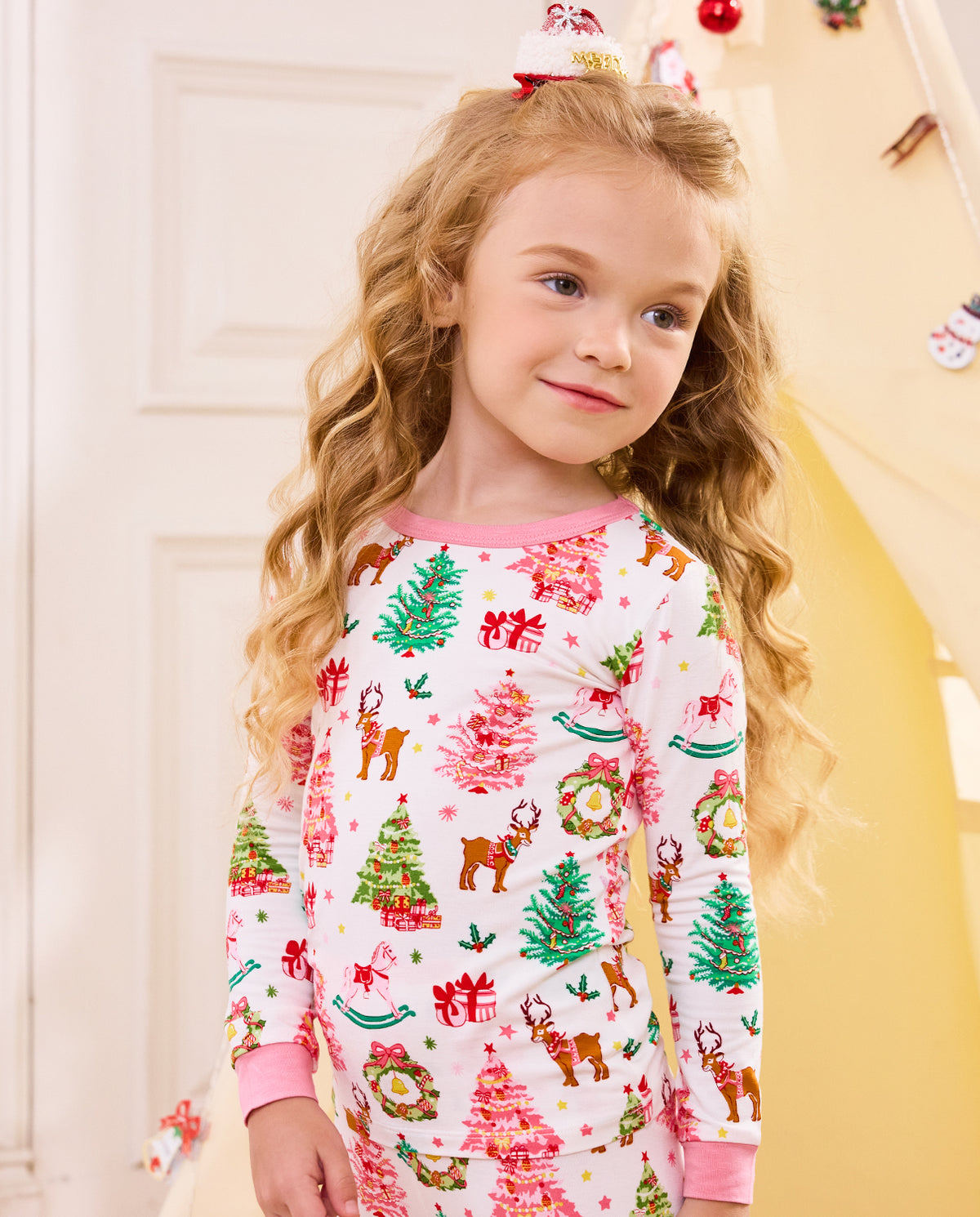 Close view of a child wearing the white Blush Christmas top with pink neckline.
