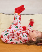 Child lying on bedding with legs raised in the Christmas Bow romper.