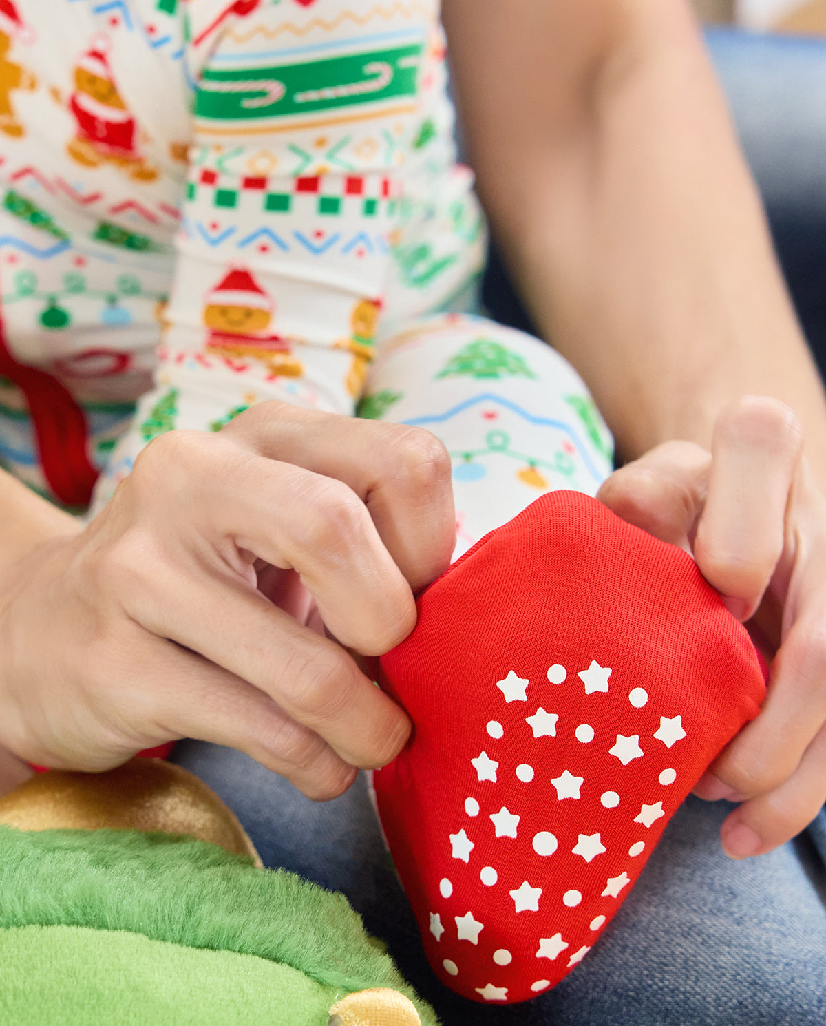 Close-up of the Christmas Fair Isle Bamboo Zippy red foot cuff with white star and dot grips