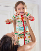 Smiling baby held up in the Christmas Fair Isle Bamboo Zippy with red zipper trim