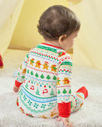 Seated back view of a baby in the Christmas Fair Isle Bamboo Zippy with snowman and Christmas tree rows