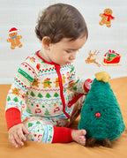 Baby seated holding a plush Christmas tree in the Christmas Fair Isle Bamboo Zippy with red cuffs
