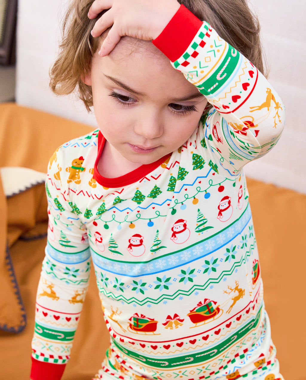 Close-up of Christmas Fair Isle red neckline and sleeve cuff as a child raises an arm