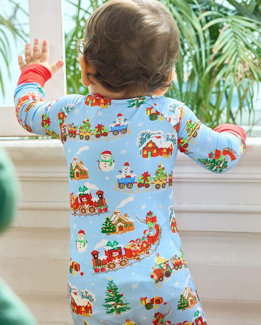 Closer back view of the Christmas Trains Bamboo Zippy showing festive trains, snowmen, gifts and trees on light blue fabric.