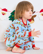 Child crouching on a seat in Christmas Trains pants with red ankle cuffs.