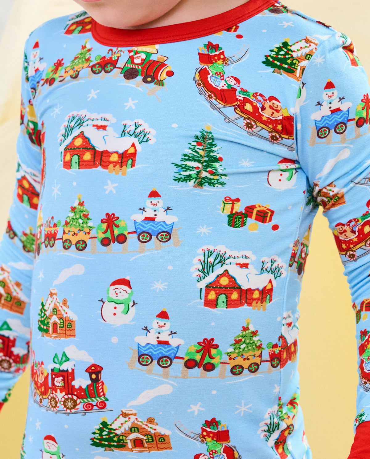Close-up of the red neckline and Santa train print on the Christmas Trains top.