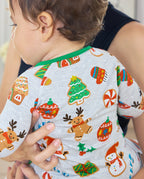 Close-up of the Gingerbread Gala print on a baby's back, with a gingerbread reindeer, cookie tree and red ornament