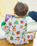 Seated back view of a baby in the Gingerbread Gala Bamboo Zippy, showing snowmen, cookie trees and gift motifs