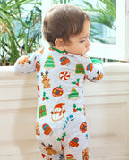 Back view of a baby wearing the Gingerbread Gala Bamboo Zippy by a window, showing gingerbread reindeer and Christmas trees