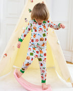 Child standing beside a rocking toy in Gingerbread Gala long-sleeve top and pants