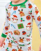 Close-up of Gingerbread Gala top with gingerbread reindeer, snowmen, gifts, and green cuffs