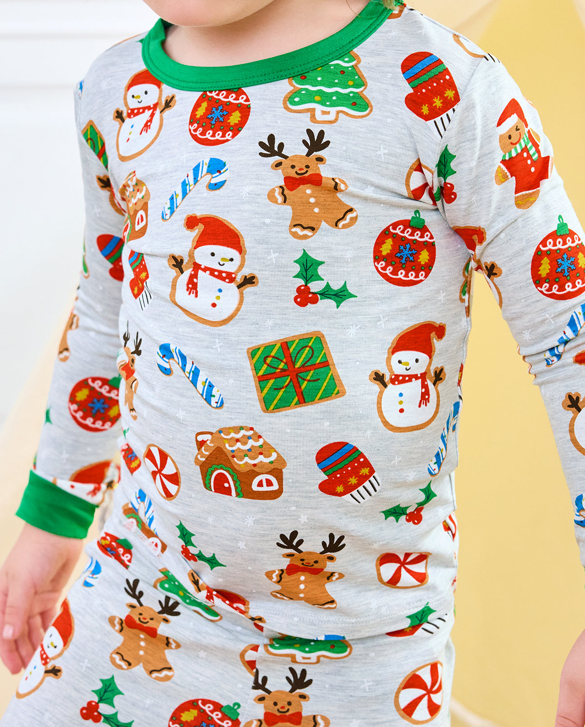 Close-up of Gingerbread Gala top with gingerbread reindeer, snowmen, gifts, and green cuffs
