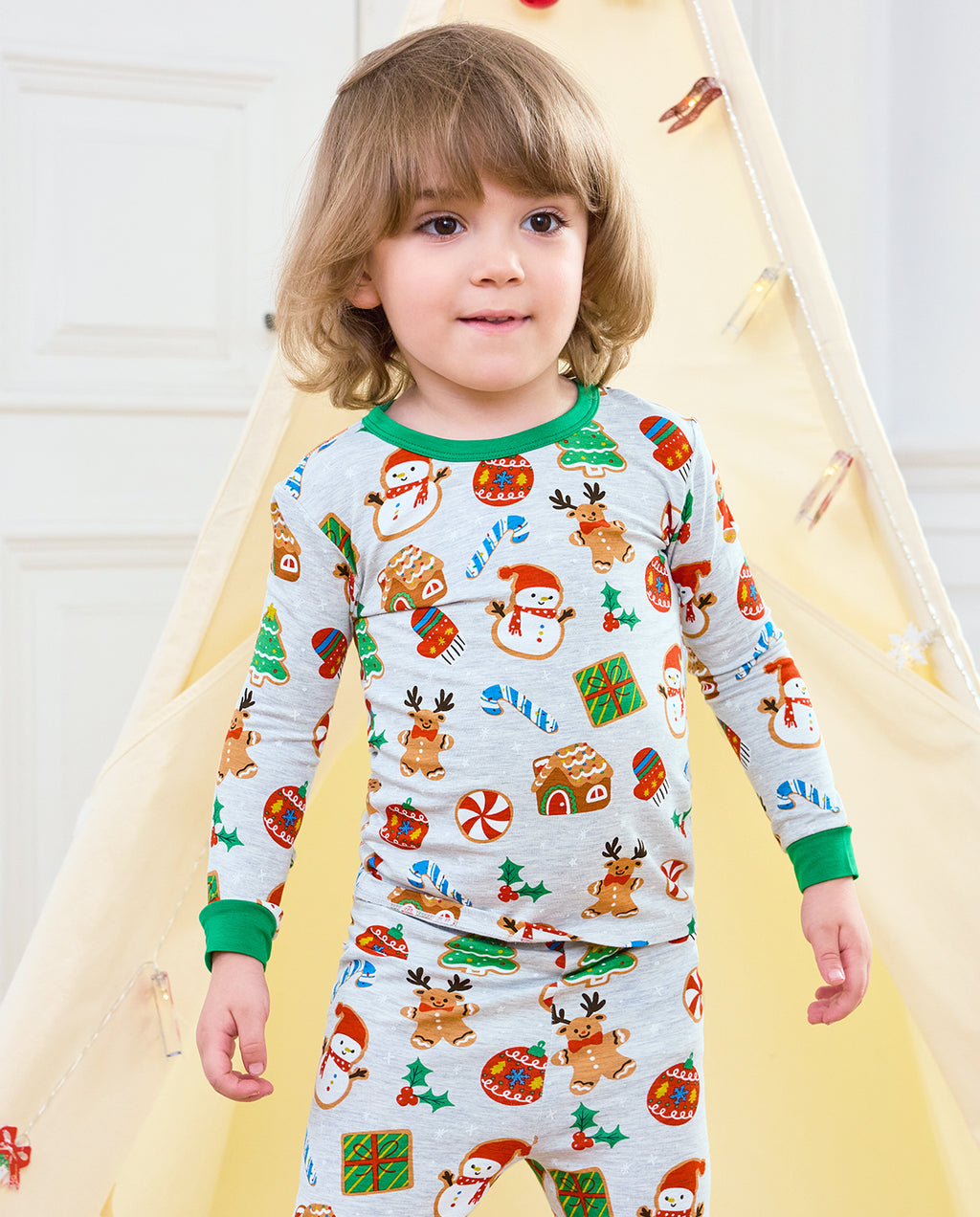 Child standing near a holiday tent in Gingerbread Gala long-sleeve pajamas