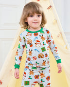 Child standing near a holiday tent in Gingerbread Gala long-sleeve pajamas