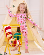 Child standing beside a yellow cart in Gingerbread Lane pajamas.