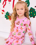 Close view of a child seated in the pink Gingerbread Lane pajama set.