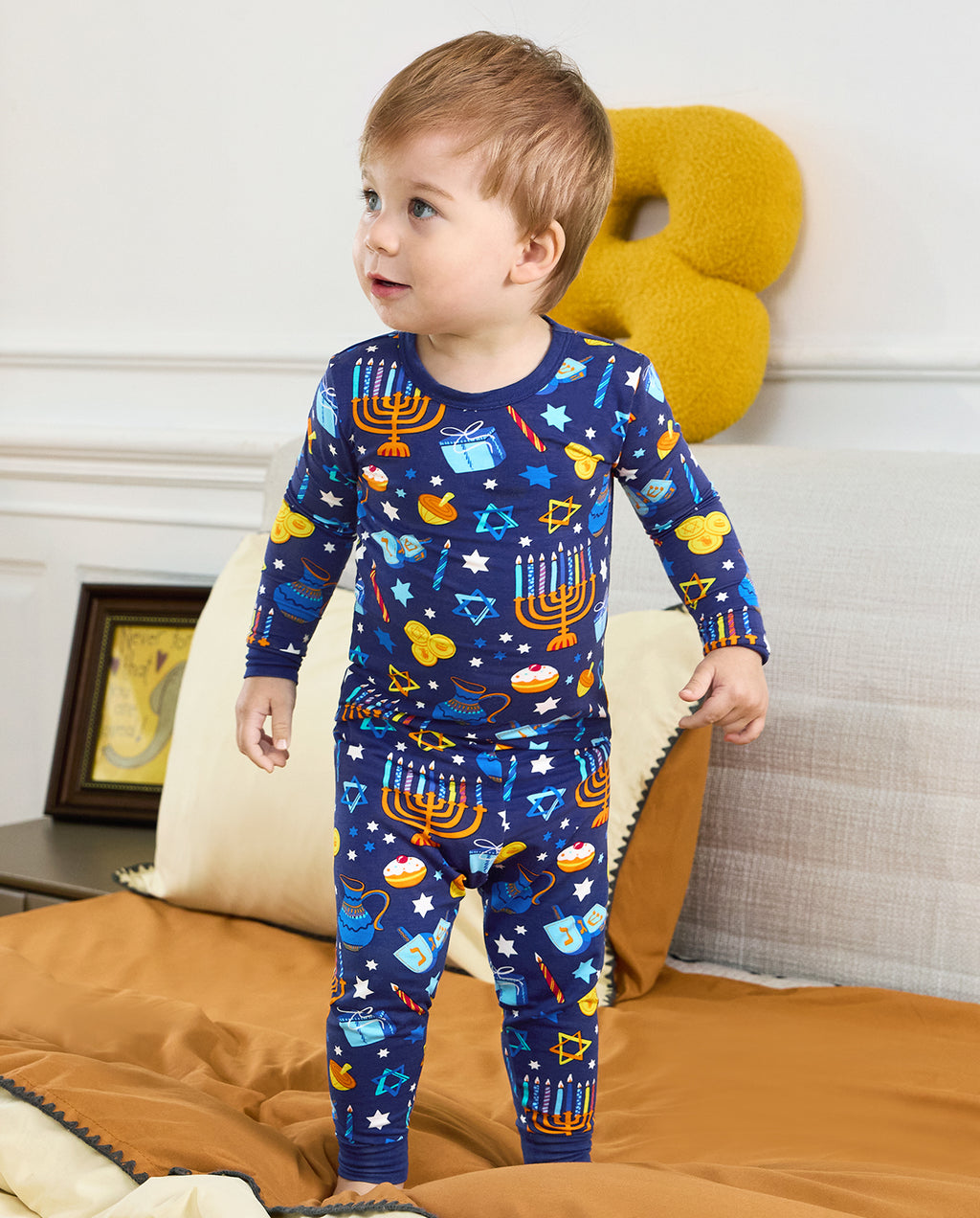 Child standing in the navy Hanukkah Magic top and matching pants.