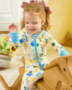 Child seated on a wooden rocking horse in the Happy Hanukkah romper with light blue cuffs.