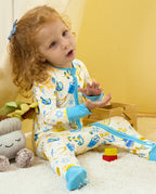 Child seated with hands raised in the Happy Hanukkah zip-up romper.