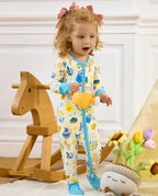 Child standing beside a wooden rocking horse in the Happy Hanukkah romper.
