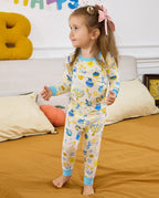 Side view of a child standing in the Happy Hanukkah long-sleeve pajama set.
