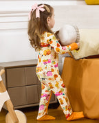 Rear view of a child standing with a round toy in the Harvest Farm romper.