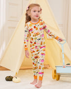 Child standing beside a blue cart and play tent in the Harvest Farm pajama set.