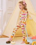 Side view of a child standing beside a cart in Harvest Farm pajamas.