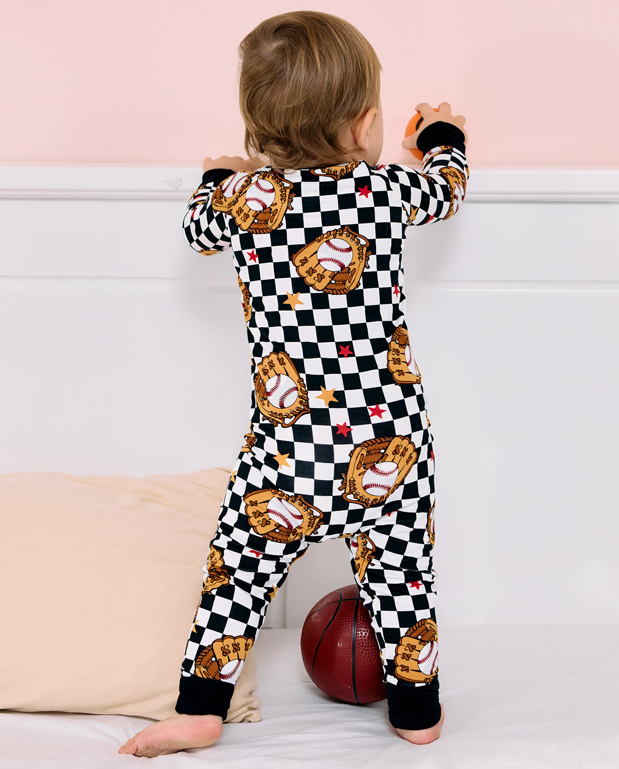 Junior Mitt Bamboo Zippy - toddler wearing the zippy while standing, back view