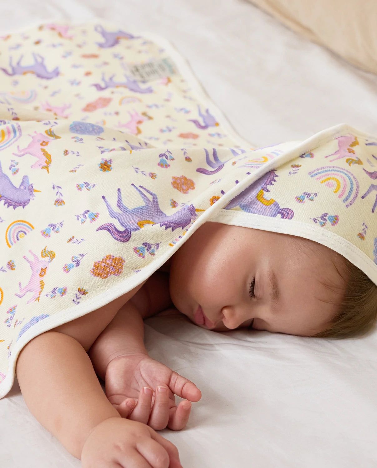 Lavender Unicorn Hooded Baby Bath Towels (2-Pack) - sleeping child covered by the unicorn-print towel