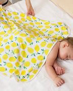 Lemon Tree Hooded Baby Bath Towels (2-Pack) - sleeping baby covered by the lemon-print towel