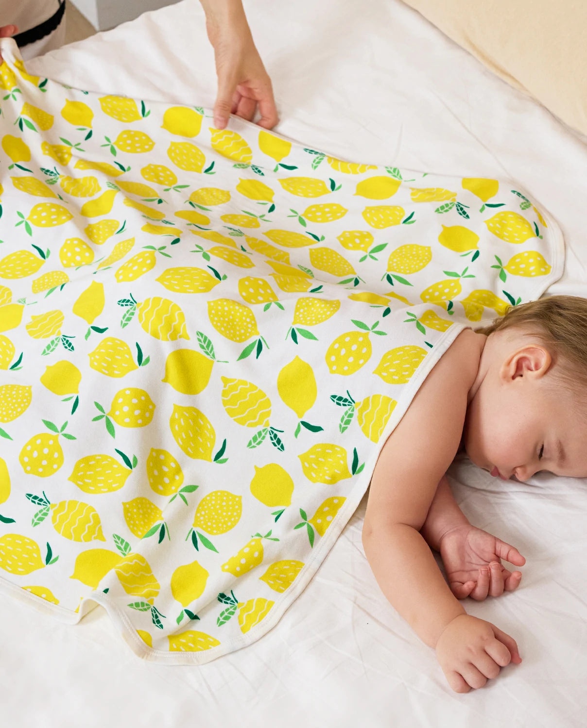Lemon Tree Hooded Baby Bath Towels (2-Pack) - sleeping baby covered by the lemon-print towel