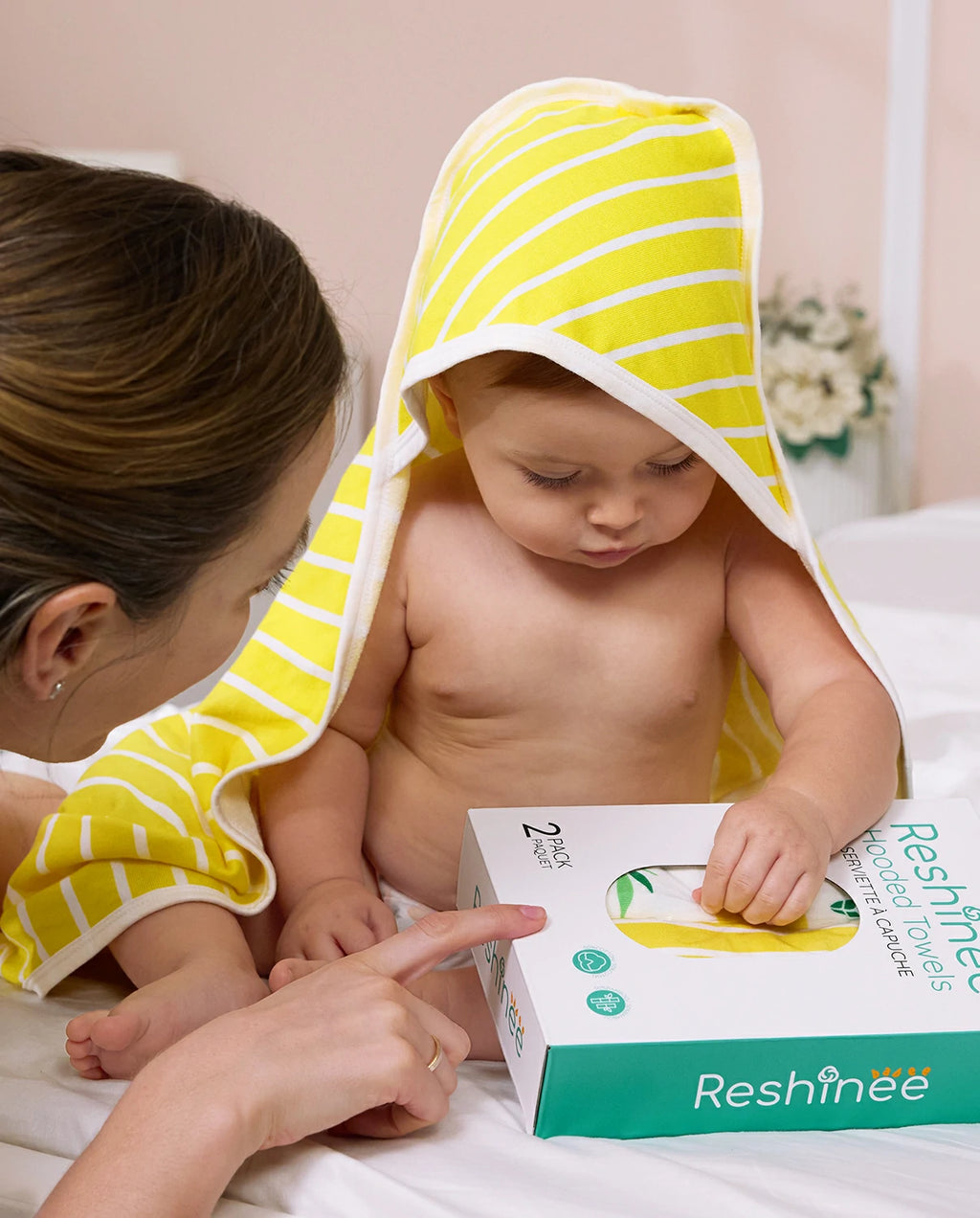 Lemon Tree Hooded Baby Bath Towels (2-Pack) - baby wearing the striped hooded towel beside the retail box