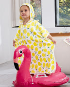 Lemon Tree Hooded Toddler Bath Towel - child wearing the hooded towel while seated on a flamingo pool float