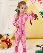 Child standing with a small toy in the pink Merry Mingo zip-up romper.
