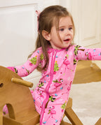 Child seated on a wooden rocking horse in the Merry Mingo romper.