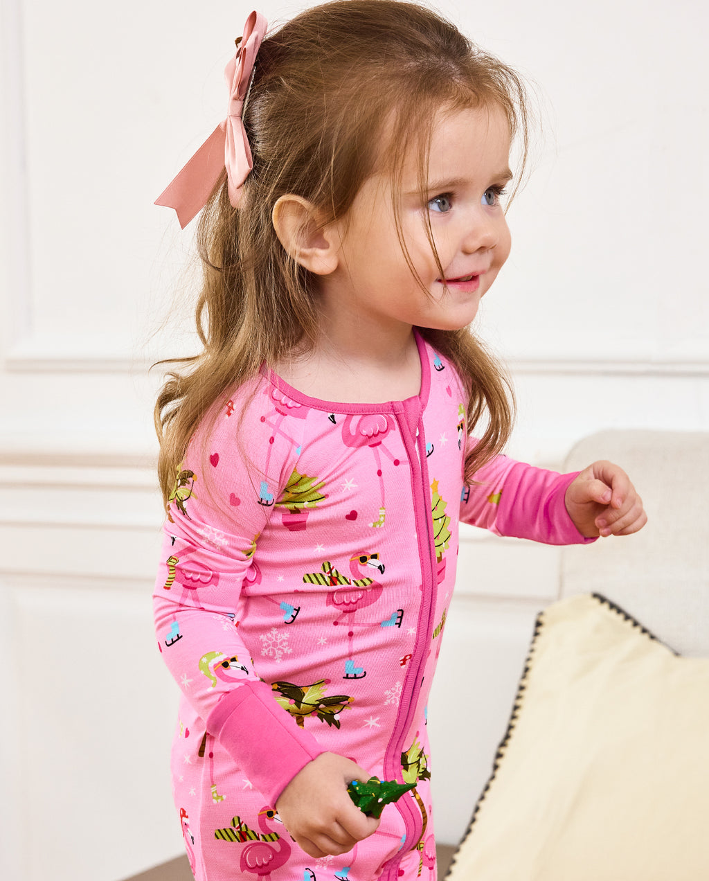 Close front view of a child seated in the Merry Mingo zip-up romper.