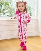 Child standing by a window with a hand to the cheek in the Merry Penguins romper.