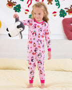 Child holding a penguin plush to the side in the Merry Penguins pajama set.