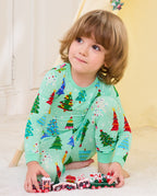 Child wearing Merry Trees mint-green two-piece pajamas while playing with toy trains