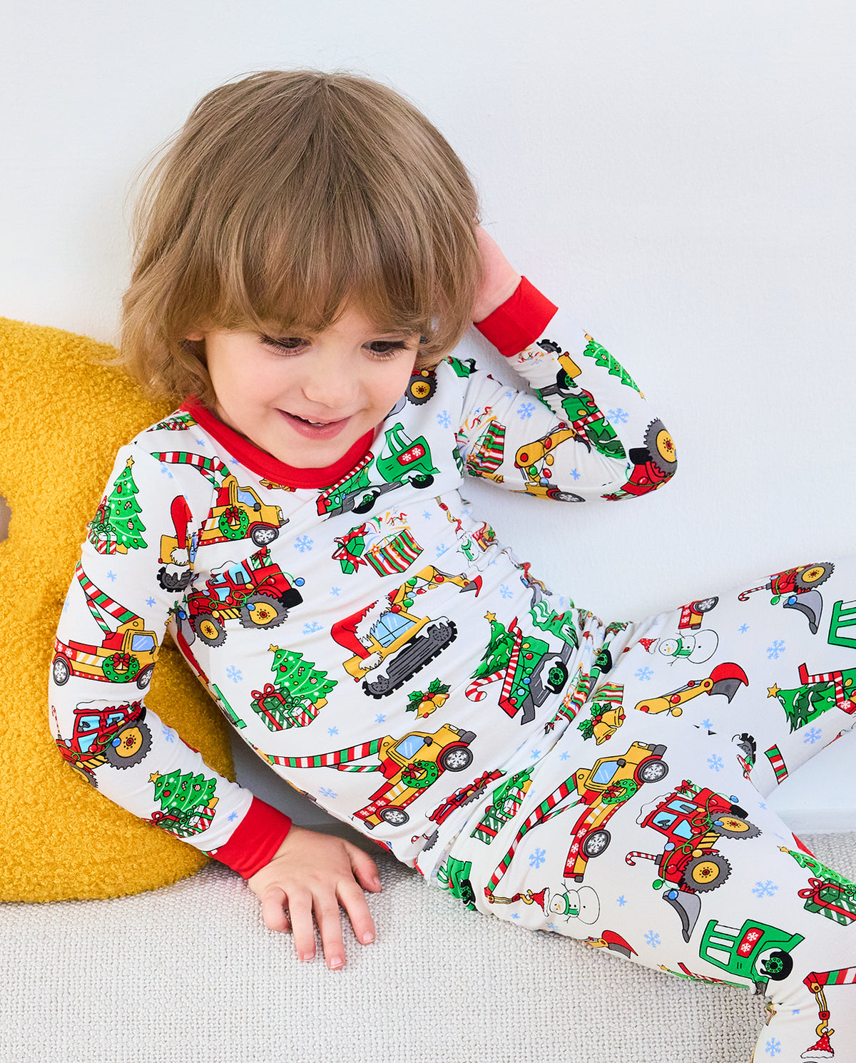 Close front view of Merry Truckmas pajamas showing festive construction vehicles