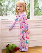 Child standing beside a window in the Nutcracker Fairy romper with lavender cuffs.