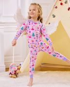 Child posing with white costume wings and a wand in Nutcracker Fairy pajamas.