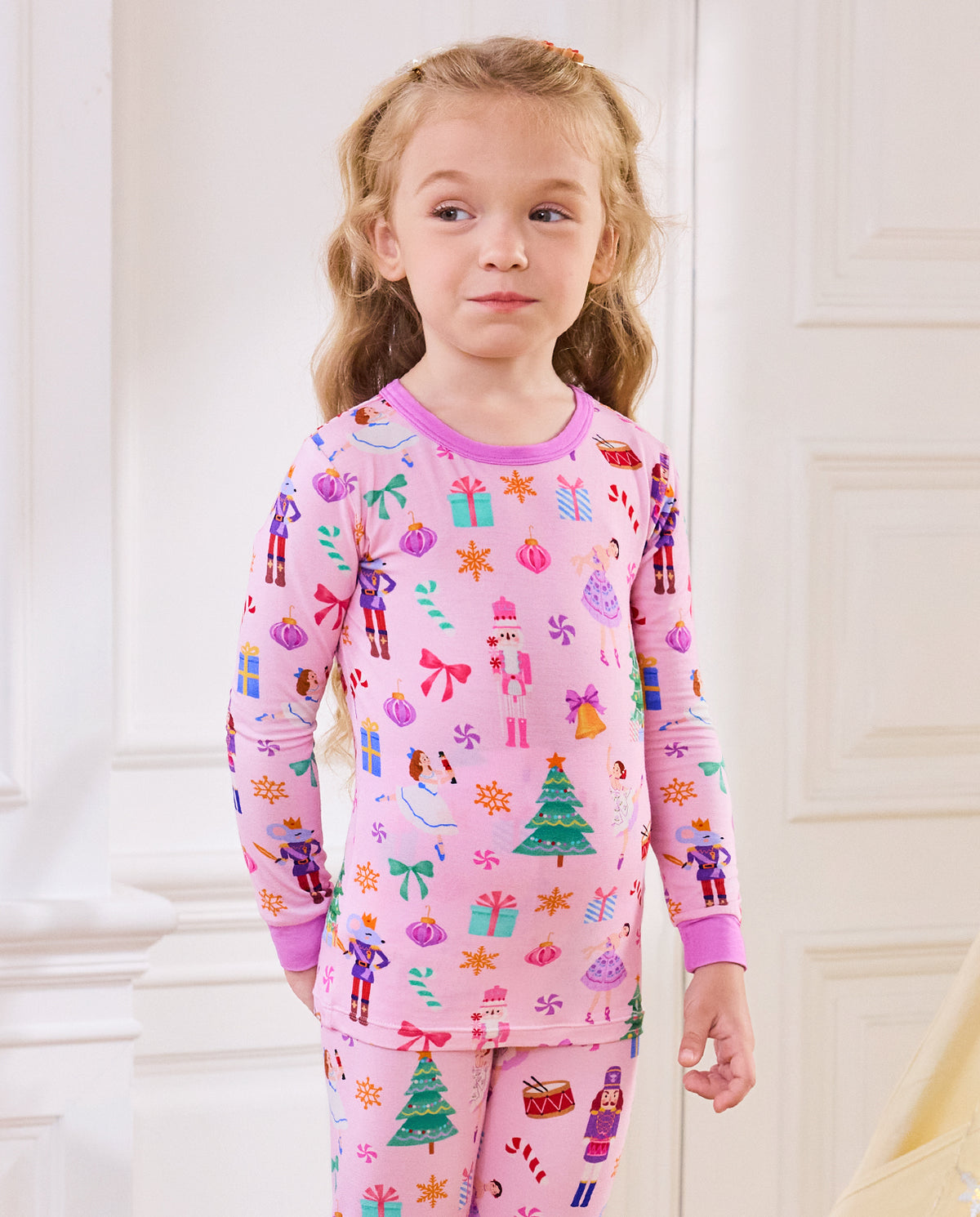 Close view of a child wearing the Pink Nutcracker long-sleeve top.