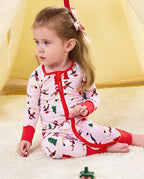 Child seated by a play tent in the Pink Penguins romper.