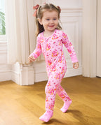Smiling child walking in the Pumpkin Bows zip-up romper with pink cuffs.