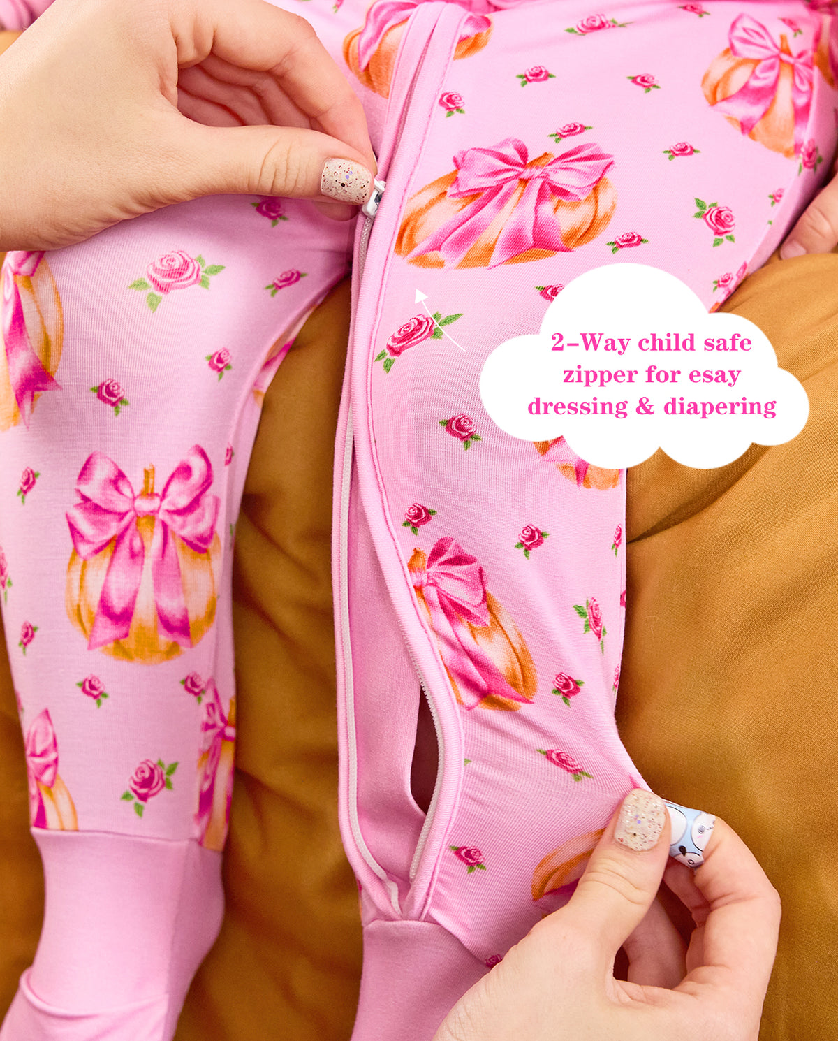 Close-up showing the pink front zipper and pumpkin bow print, with the original product annotation.